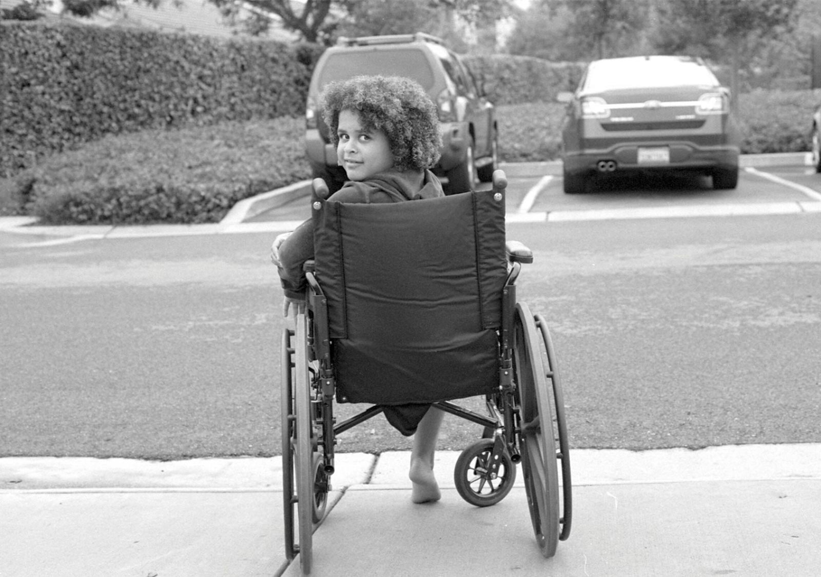 A Young Girl Sitting In Her Wheelchair
