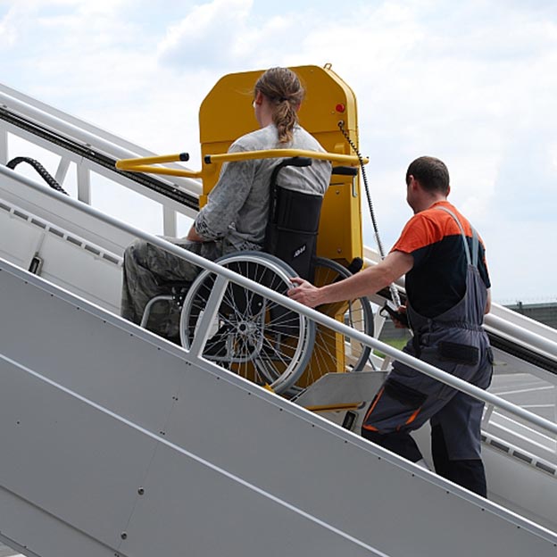 Aeroplane wheelchair user lift in use on steps